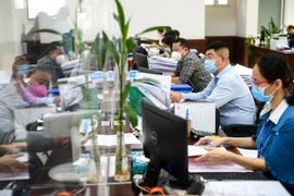 Civil servants of Phu Nhuan district in HCM City handle administrative procedures for citizens (Photo: tuoitre.vn)