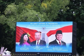 A poster on the state visit to Indonesia by Vietnamese Party General Secretary To Lam (centre) and his spouse (Photo: VNA) 